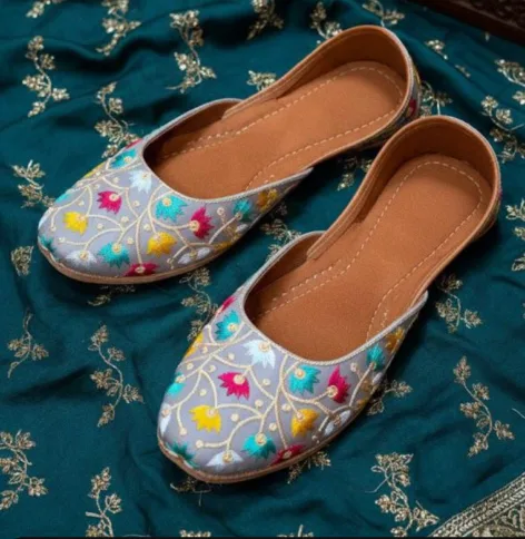 These are embroidered juttis (traditional Indian flat shoes)